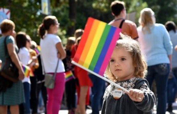 A Montenegrin child holds the rainbow flag during a Lesbian, Gay, Bisexual and Transgender (LGBT) Pride march in Podgorica, Montenegro, 23 September 2017. Hundreds of gay activists and supporters marched in the streets of Podgorica calling for more rights. LGBT rights are a controversial issue in Montenegro and elsewhere in the Balkan region, where the society is considered a more conservative one. Montenegrians first LGBT Pride in July 2013 ended with police firing warning shots to the air to disperse anti-gay nationalists who stoned and beat participants. Gay Pride rally in Podgorica, Montenegro - 23 Sep 2017