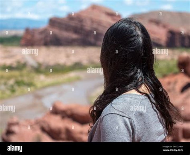 A woman looks at the scene of the El Paso Walmart massacre