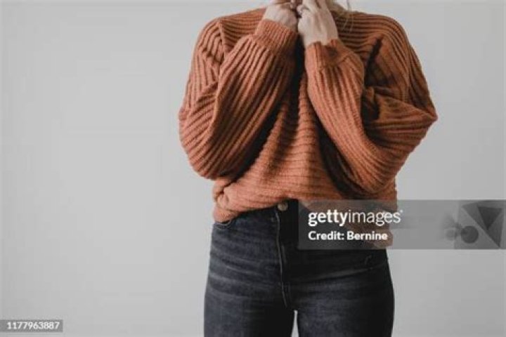 A woman wearing a sweater.