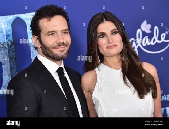 Aaron Lohr, Idina Menzel. Aaron Lohr, left, and Idina Menzel arrive at the Oscars, at the Dolby Theatre in Los Angeles 92nd Academy Awards - Arrivals, Los Angeles, USA - 09 Feb 2020