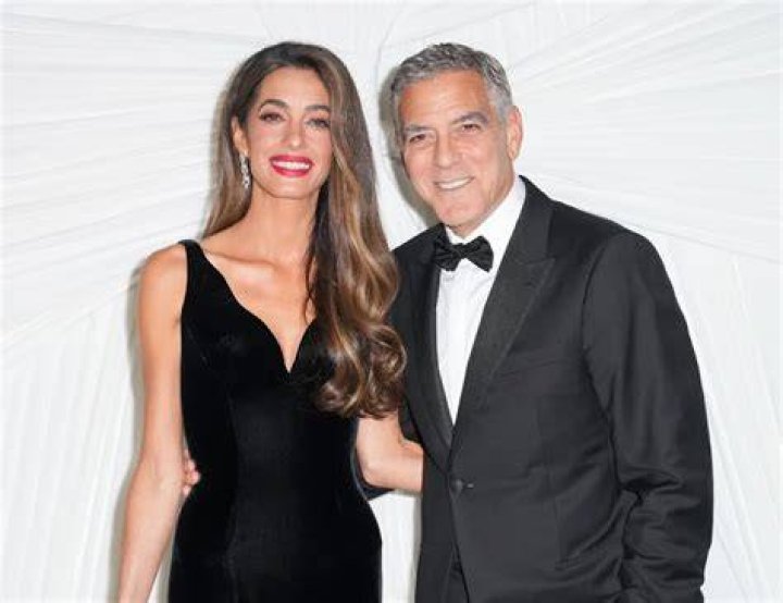 Amal Clooney & George Clooney pose and smile