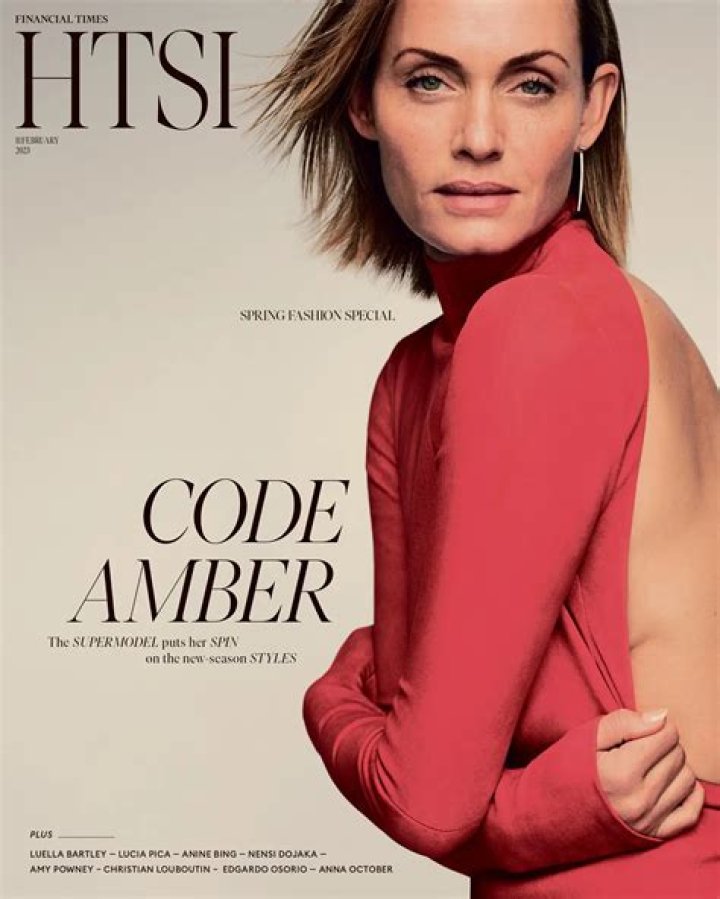 Amber Heard covers her chest after her breast pops out