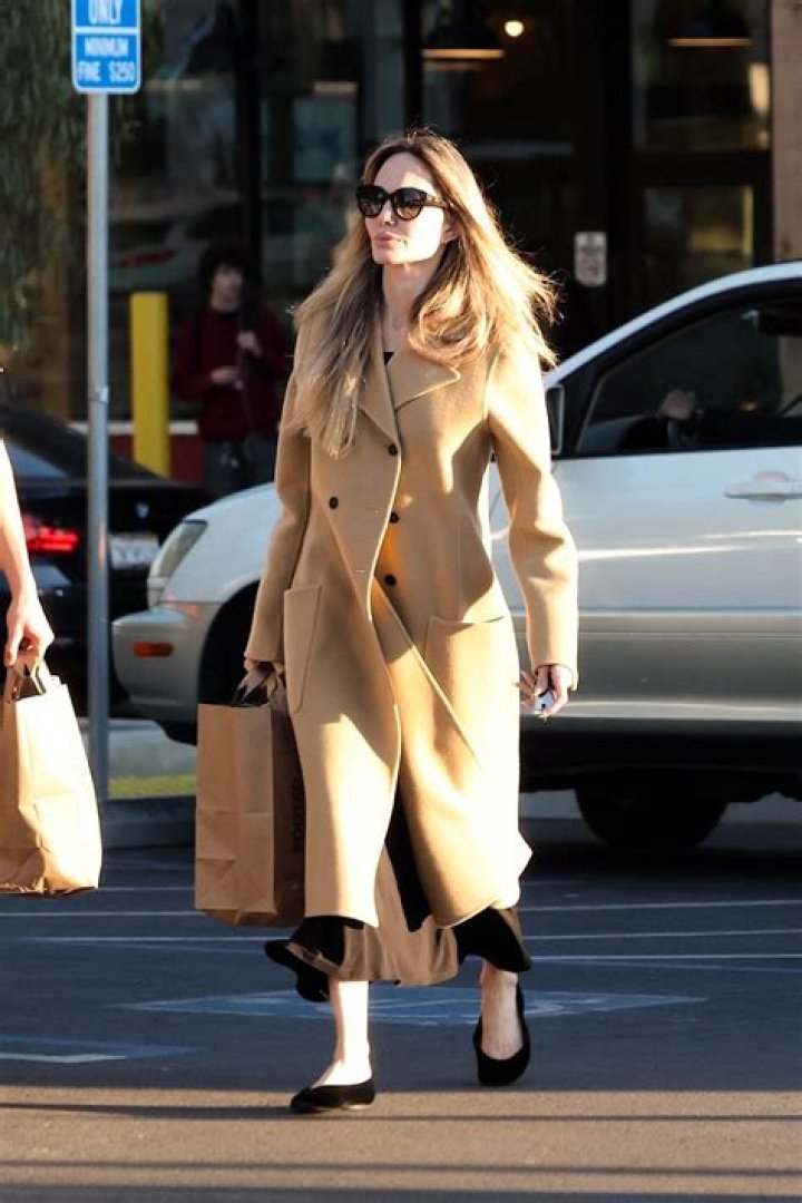 Angelina Jolie was spotted shopping at an Ethiopian Boutique store with her kids Zahara and Shiloh in Los Angeles, CA. They were seen walking through the aisles as they checked out the various Ethiopian Garb and clothing on the racks. 08 Jan 2021 Pictured: Angelina Jolie wears all white as she takes her kids Zahara and Shiloh shopping at an Ethiopian boutique in Los Angeles. Photo credit: Marksman / MEGA TheMegaAgency.com +1 888 505 6342 (Mega Agency TagID: MEGA725340_013.jpg) [Photo via Mega Agency]
