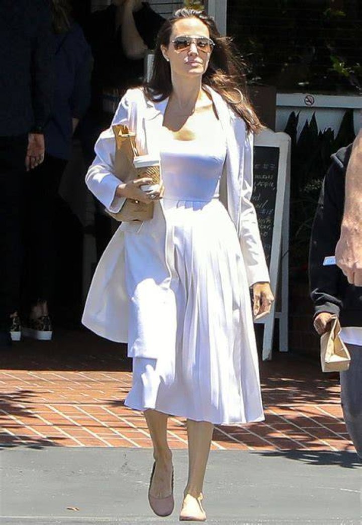 Angelina Jolie wears all white as she takes her kids Zahara and Shiloh shopping at an Ethiopian boutique in Los Angeles. The trio were seen arriving at Sorella and picking out some clothes off the racks. 08 Jan 2021 Pictured: Angelina Jolie wears all white as she takes her kids Zahara and Shiloh shopping at an Ethiopian boutique in Los Angeles. Photo credit: Marksman / MEGA TheMegaAgency.com +1 888 505 6342 (Mega Agency TagID: MEGA725337_003.jpg) [Photo via Mega Agency]