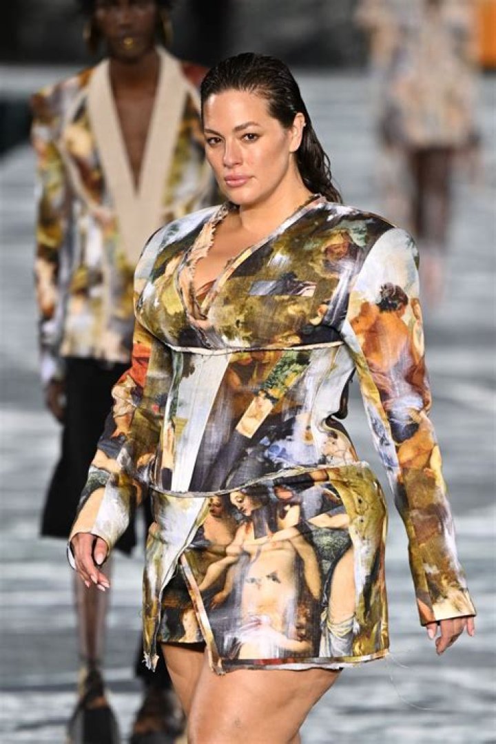 Ashley Graham models a white swimsuit