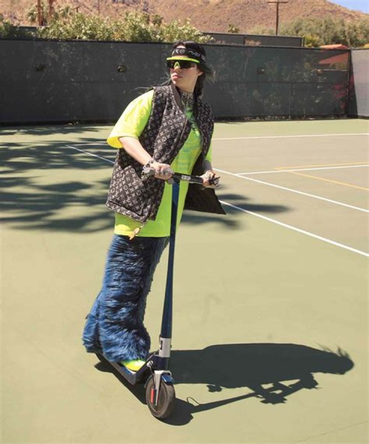 Billie Eilish rides a scooter on the tennis court at the 5th annual Interscope Coachella party. The 5th Annual Interscope Coachella Party, Coachella Valley Music and Arts Festival, Weekend 1, Day 2, Palm Springs, USA - 13 Apr 2019