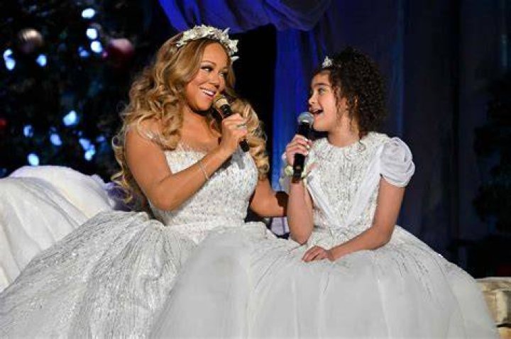 CBS presents MARIAH CAREY: MERRY CHRISTMAS TO ALL!, a new two-hour primetime concert special from the Queen of Christmas Mariah Carey, broadcasting Tuesday, Dec. 20 (8:00-10:00 PM, ET/PT) on the CBS Television Network, and available to stream live and on demand on Paramount+. Pictured (L-R): Santa Claus and Mariah Carey. Photo: James Devaney/CBS &copy;2022 CBS Broadcasting, Inc. All Rights Reserved.