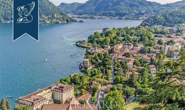 CERNOBBIO, ITALY - *EXCLUSIVE* - Actor George Clooney and his wife Amal enjoy their family holidays in the province of Como.The 61-year-old The Ocean's Eleven actor looked casual in his blue top during a boat ride with Amal who was stunned in her summer dress and hat, taking in the sights of their picturesque surroundings during the family trip.Pictured: George Clooney - Amal Clooney BACKGRID USA 13 JULY 2022 BYLINE MUST READ: COBRA TEAM / BACKGRIDUSA: +1 310 798 9111 / : +44 208 344 2007 / *UK Clients - Pictures Containing ChildrenPlease Pixelate Face Prior To Publication*