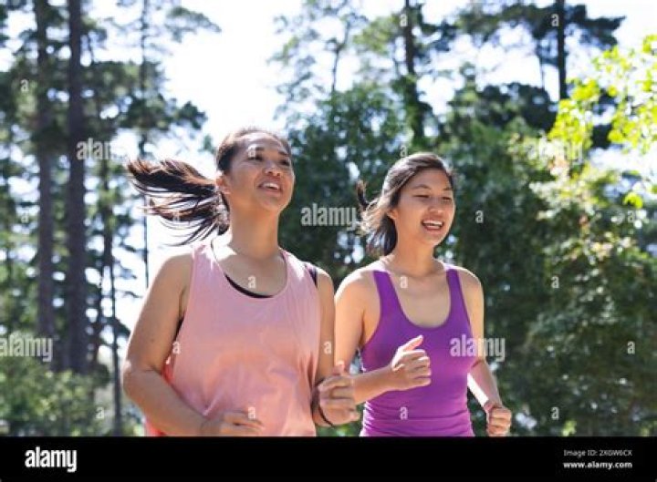 Cheerful female friends running around the park with American flag. Young and enthusiastic American girls enjoying 4th of july holiday at park.; Shutterstock ID 1377382046; Comments: art use