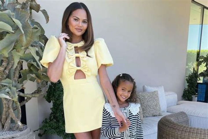 Chrissy Teigen, 34, Twins With Daughter Luna, 3, In Cute White One-Piece Bathing Suits & Sunglasses