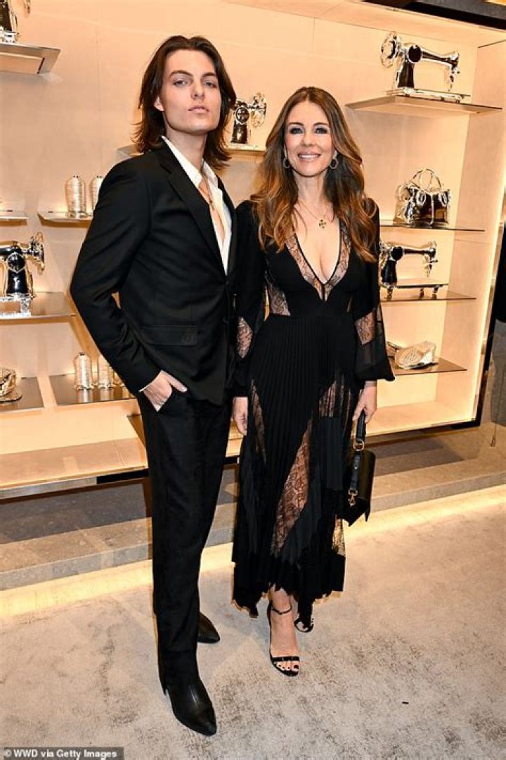 Damian Hurley wearing a black Versace suit in London
