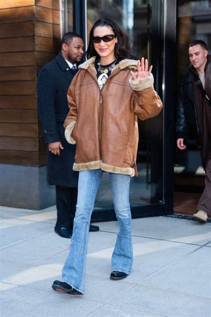 EXCLUSIVE: Supermodel Bella Hadid wears a cute cropped top and trucker hat with plenty of bangle bracelets as she has lunch with a friend in Miami. The famous catwalker went unnoticed in her casual attire, and left lunch with not one but two green juices for the road. 06 Apr 2021 Pictured: Bella Hadid. Photo credit: MEGA TheMegaAgency.com +1 888 505 6342 (Mega Agency TagID: MEGA744665_003.jpg) [Photo via Mega Agency]