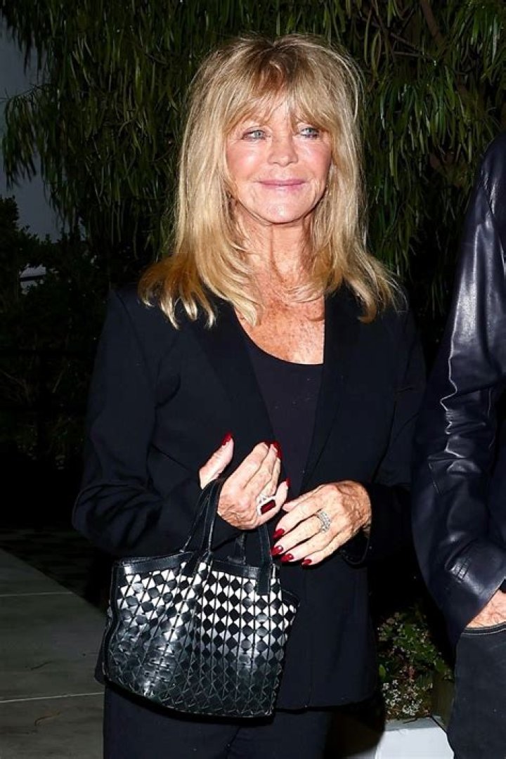 Goldie Hawn in a black swimsuit and skirt