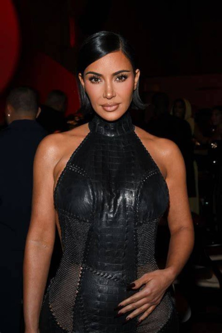 Kim In a black leather dress