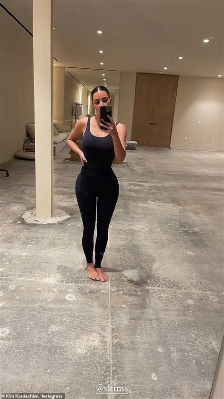 Kim Kardashian In A Bodysuit With North West
