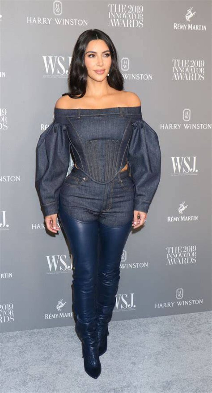 Kim Kardashian showing off her snakeskin boots
