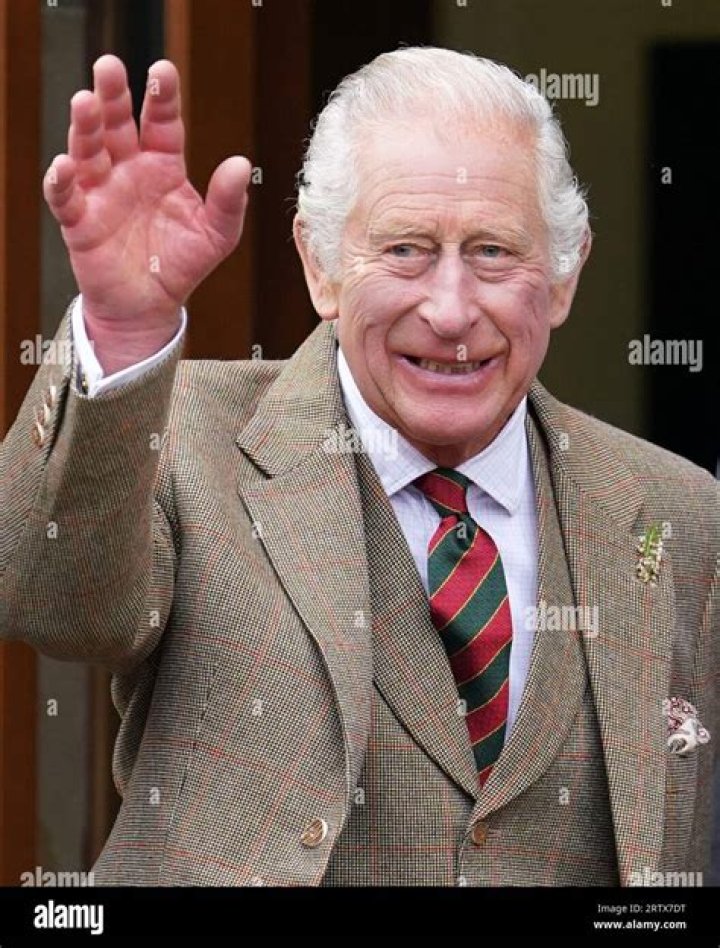 King Charles III waves to supporters
