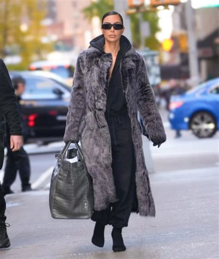 Kourtney Kardashian walking in snakeskin boots