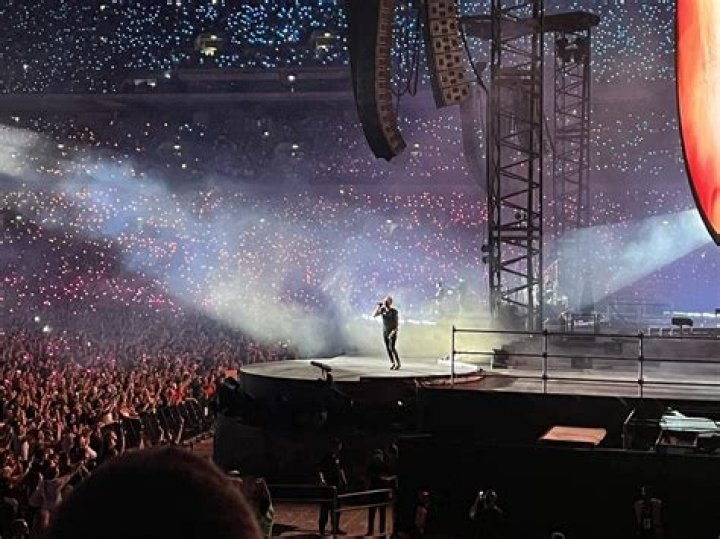 Olivia Newton-John Honored By Coldplay With Gorgeous ‘Summer Night’s Rendition On Tour