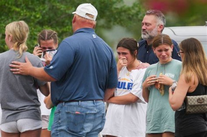 People comforting each other outside a mass shooting at Wal-Mart in El Paso