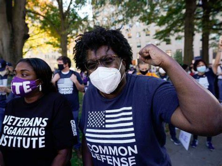 People gathered in Black Lives Matter Plaza, react to the presidential race being called in Joe Biden's favor, Saturday, Nov. 7, 2020, in Washington. (AP Photo/Alex Brandon)