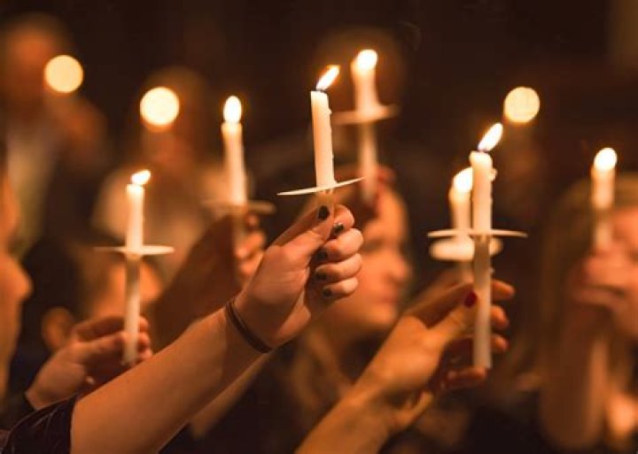 People grieve at a candlelight vigil