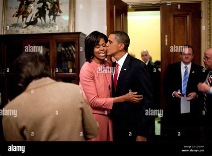 President Barack Obama kisses first lady Michelle Obama as they await for the arrival of President-elect Donald Trump and his wife Melania, Friday, Jan. 20, 2017, at the White House in Washington. (AP Photo/Evan Vucci)
