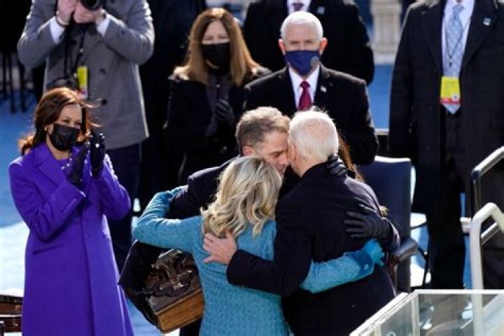 President Joe Biden hugs first lady Jill Biden as they arrive at the North Portico of the White House, Wednesday, Jan. 20, 2021, in Washington. (AP Photo/Evan Vucci)