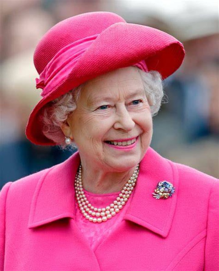 Queen Elizabeth smiling in pink
