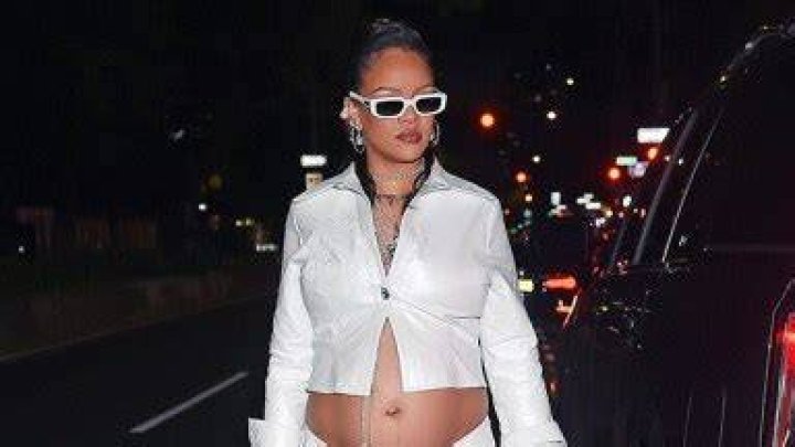 Rihanna Brushes Sparkles Over Her Bare Baby Bump As She Rocks A Silver Crop Top For Fenty Beauty