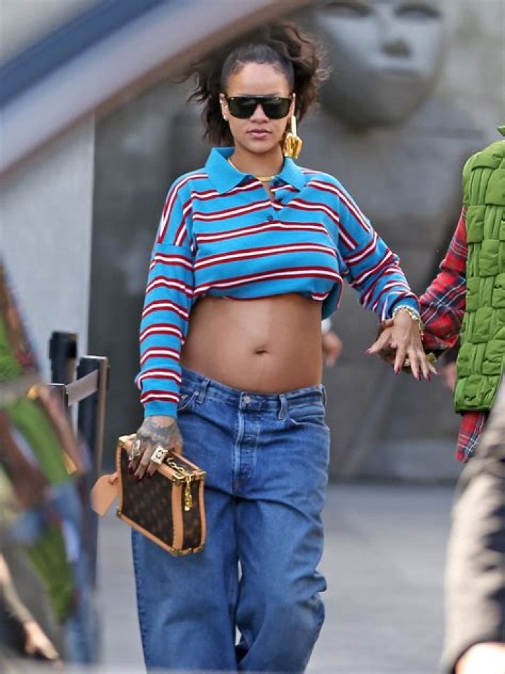 Rihanna wearing a flowy button down shirt