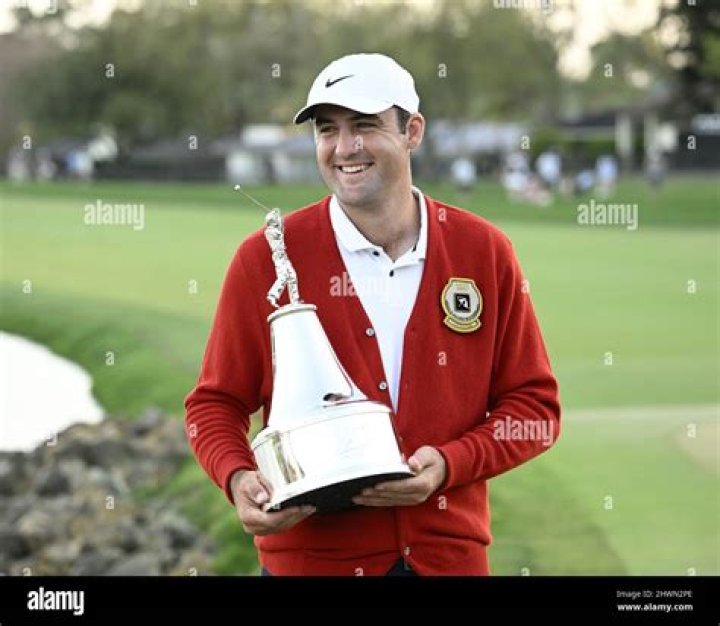 Scottie Scheffler holds the Arnold Palmer Invitational trophy with his wife Meredith after winning the Tournament presented by Mastercard at the Bay Hill Club and Lodge in Orlando, Florida on Sunday, March 6, 2022. Scottie Scheffler Wins the 44th Arnold Palmer Invitational at Bay Hill Club in Orlando Florida, United States - 06 Mar 2022
