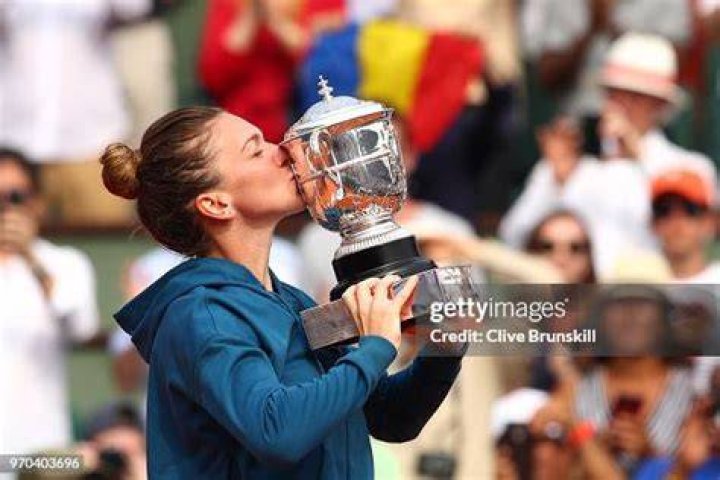 Simona Halep celebrates victory with the trophy in her Ladies' Singles final Wimbledon Tennis Championships, Day 12, The All England Lawn Tennis and Croquet Club, London, UK - 13 Jul 2019