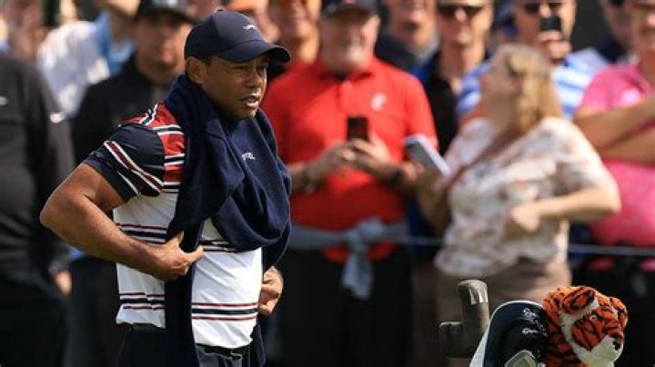 Tiger Woods Puts On A Glove