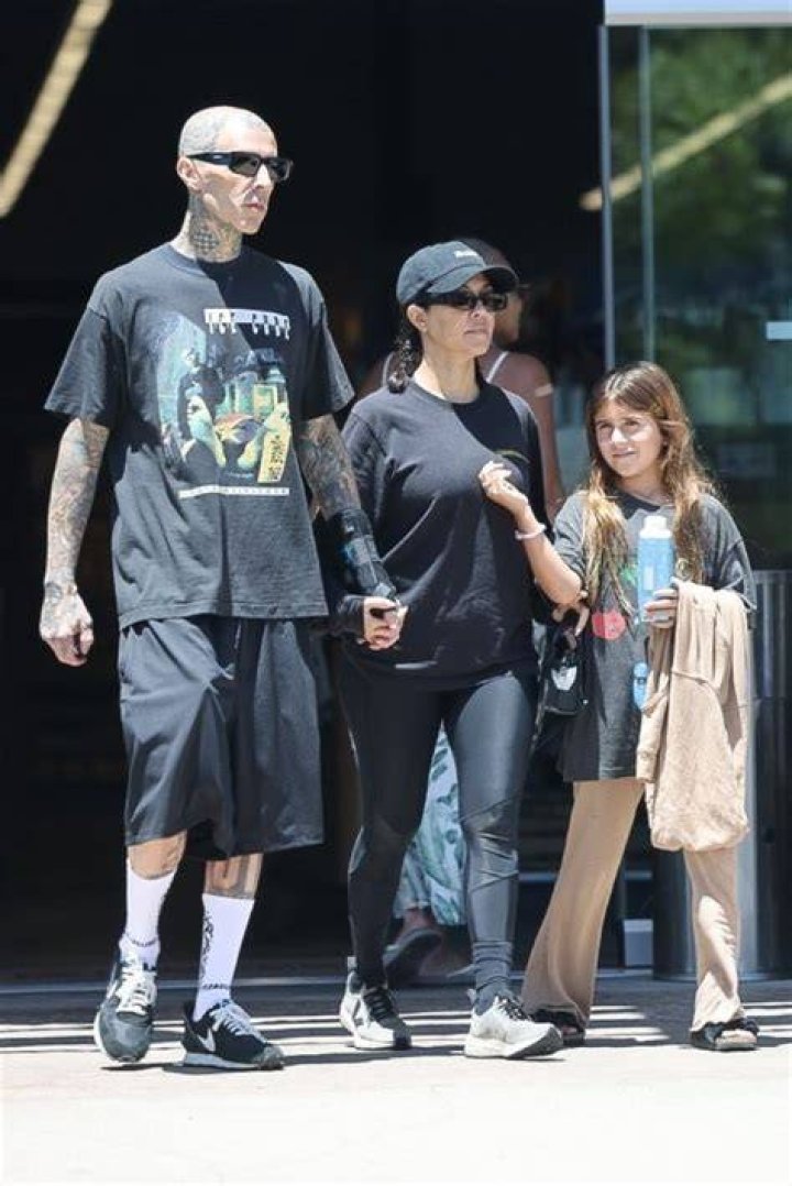 Travis Barker Carries Penelope