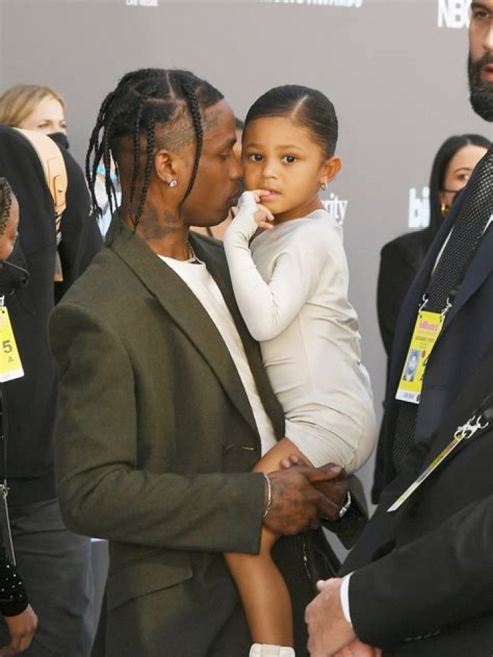 Travis Scott holds Stormi