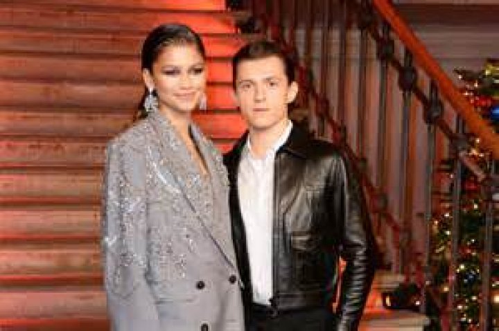 Zendaya & Tom Holland pose on a red carpet